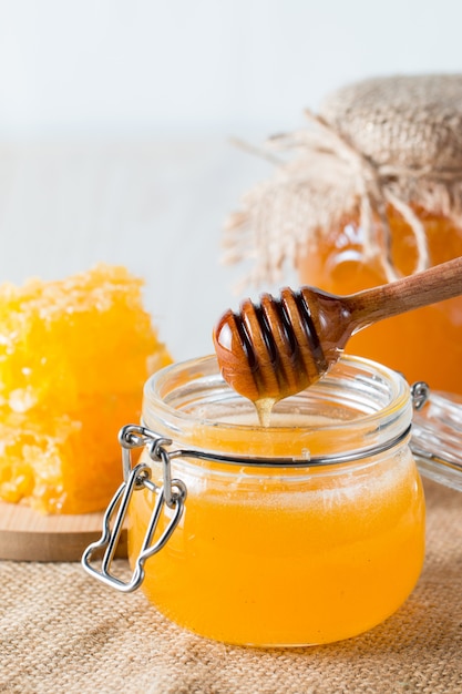 Honey in a jar on wooden rustic background