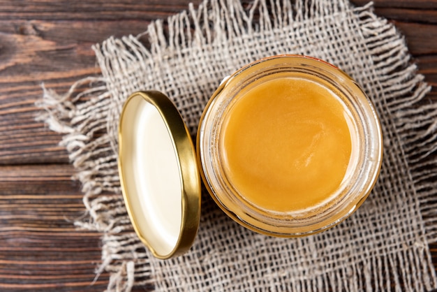 Honey in a jar on the wooden table