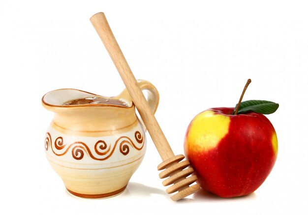 Photo honey in a jug and apple