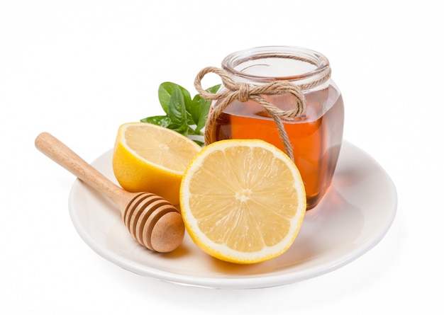 Honey, lemon and ginger on a wooden background