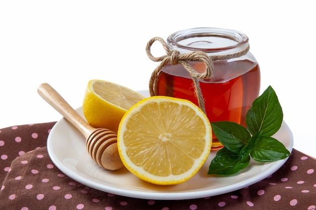 Honey, lemon and ginger on a wooden background