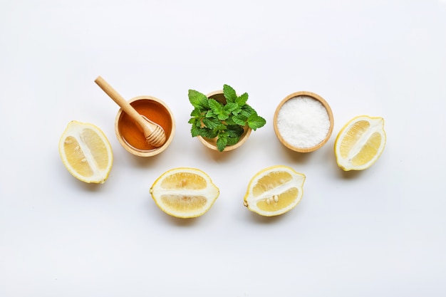 Honey , lemon, mint and salt on white background.