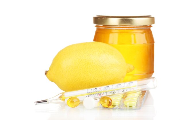 Honey lemon and thermometer isolated on white