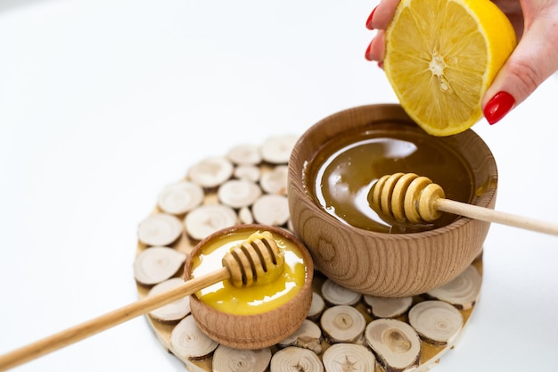 Photo honey and lemon on a white background.