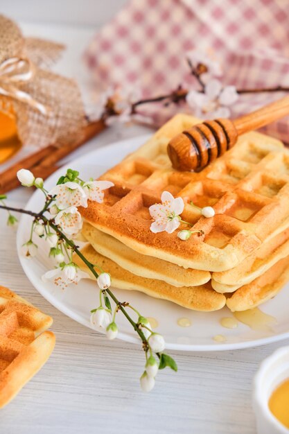 Honey pouring on a fresh Belgian waffles