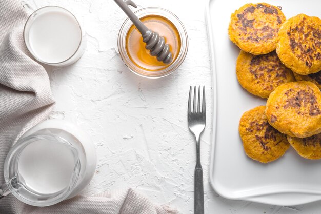 Honey pumpkin pancakes hemp milk on a white table frame