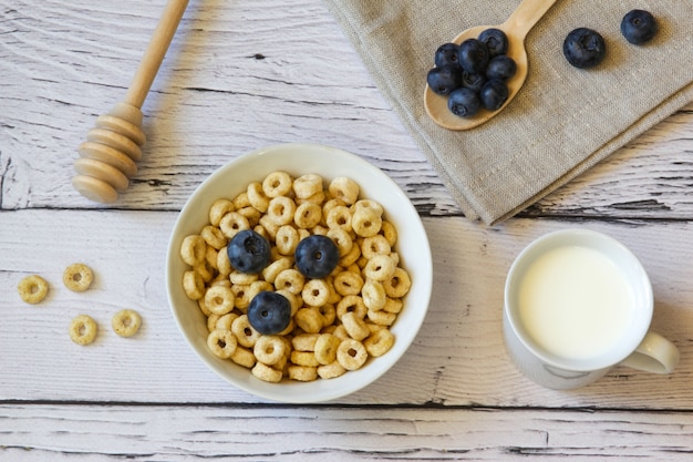 Honey rings with blueberries and honey in a bowl on the table wooden background Healthy breakfast