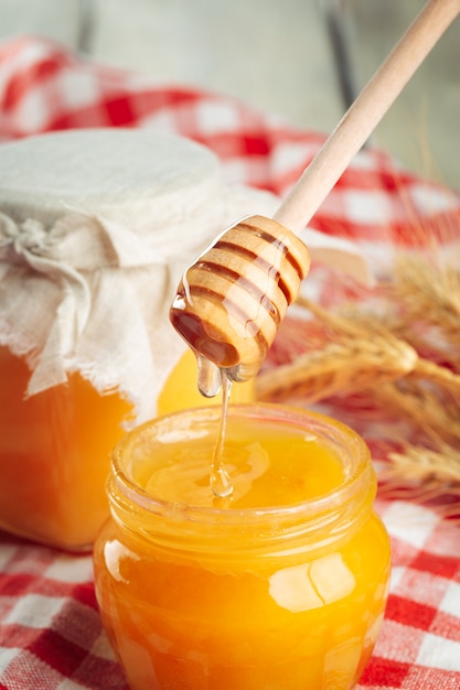 Honey. Sweet honey in glass jar on wooden.