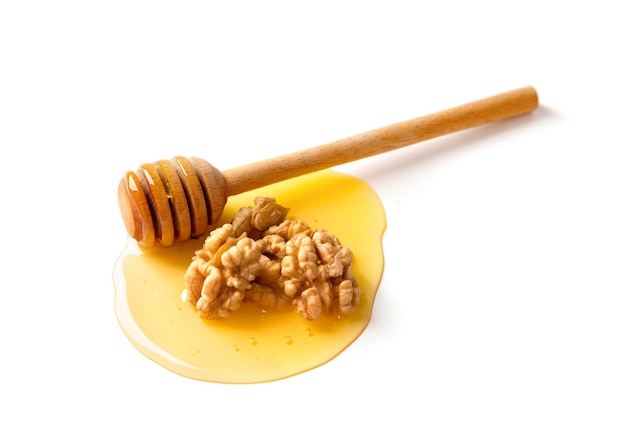 Honey and walnuts on a white background