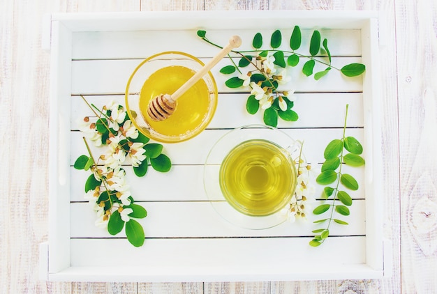 Honey with acacia and tea. Selective focus.