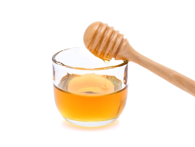 Honey with honey stick isolated on white background