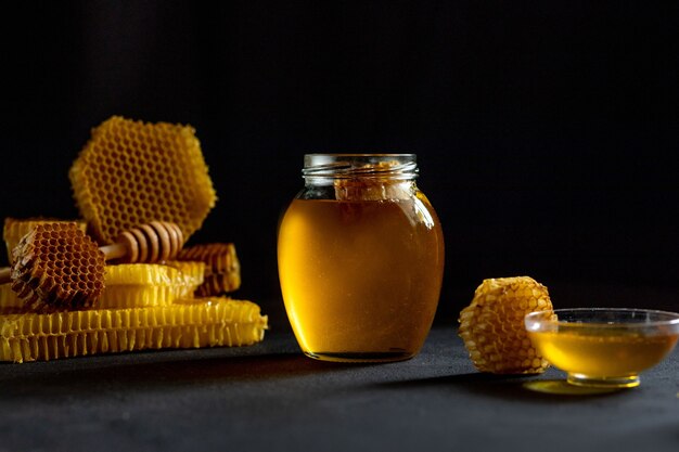 Honey with honeycomb on table