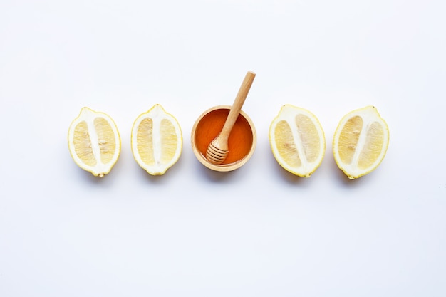 Honey with lemon on white background. Copy space