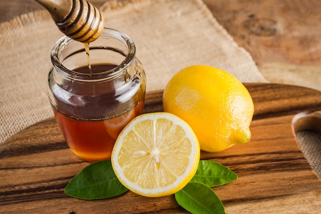 Honey with lemon on white background 