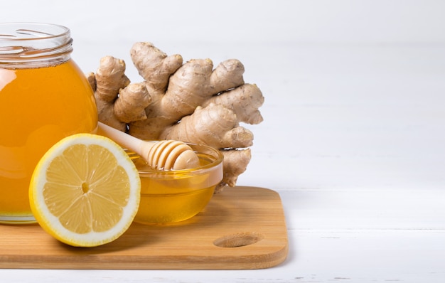 Honey with lemon on wooden table background