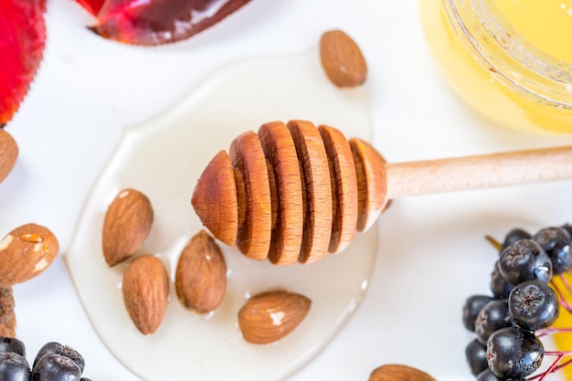 Honey with nuts in autumn leaves