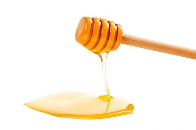 honey with wooden drizzler isolated on white 