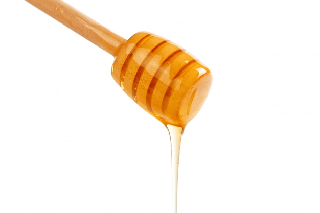 Honey with wooden drizzler isolated