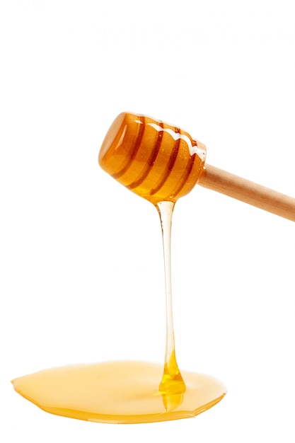 Honey with wooden drizzler isolated