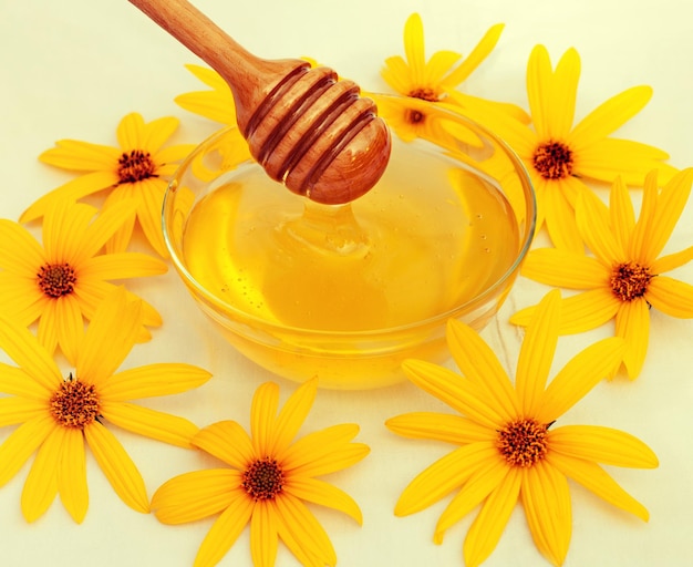 Honey and wooden spoon decorated with flowers