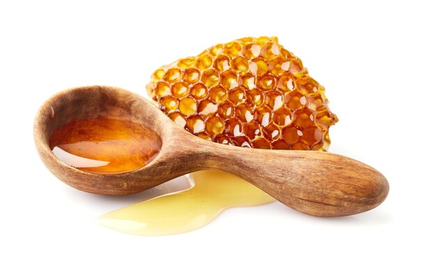 Honey in wooden spoon with honeycomb