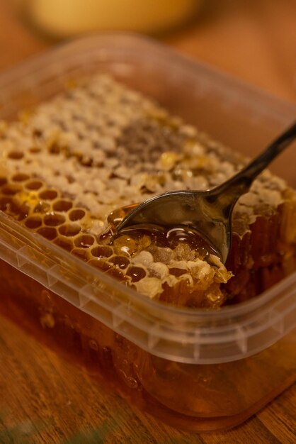 honeycomb close up in a christmas new year interior on a wooden table with candles around