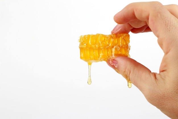 Honeycomb dripping with fingers isolated