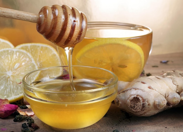 A honeycomb is poured into a bowl of honey.