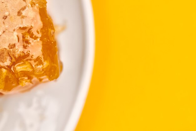 Photo honeycomb on plate, copy space, macro close up. delicious and useful dessert. love for sweets.