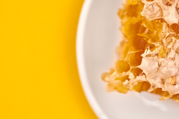 Honeycomb on plate, copy space, macro close up. Delicious and useful dessert. Love for sweets.