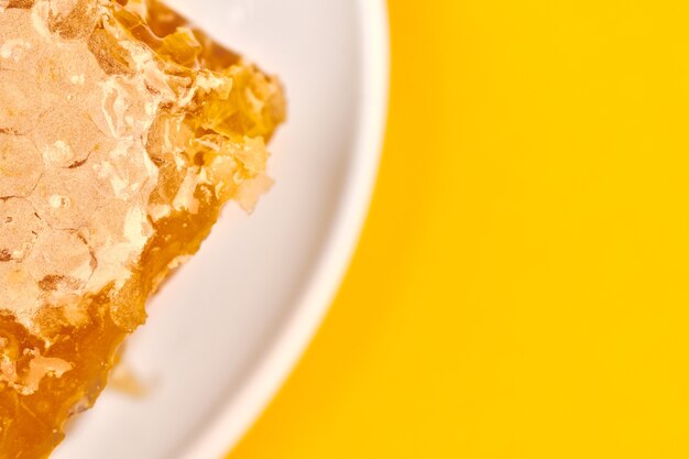 Honeycomb on plate, copy space, macro close up. Delicious and useful dessert. Love for sweets.