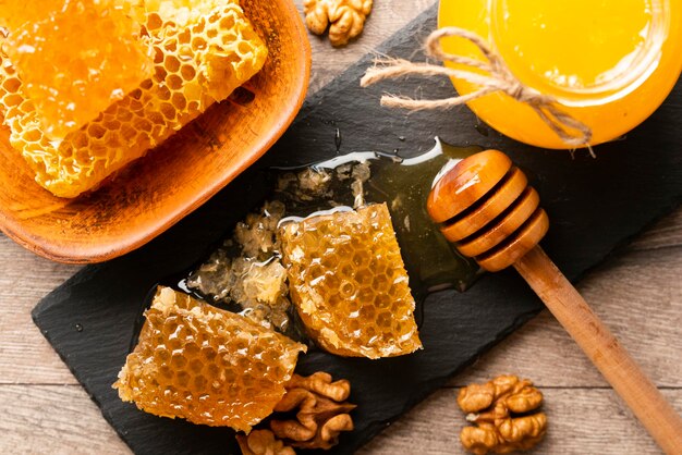 Honeycomb on slate tray with honey and nuts on kitchen table