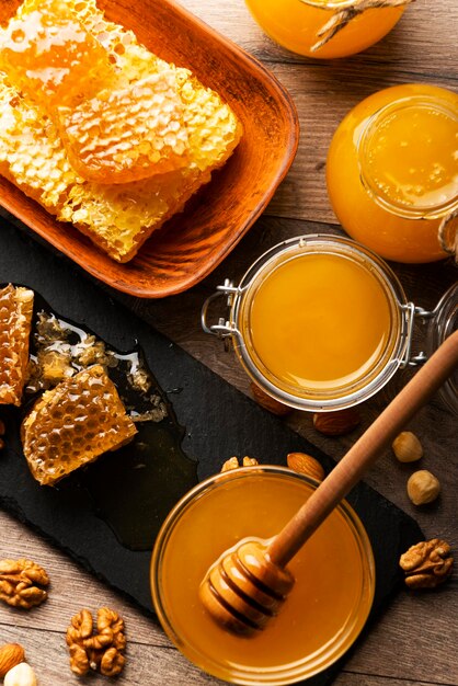 Honeycomb on slate tray with honey and nuts on kitchen table