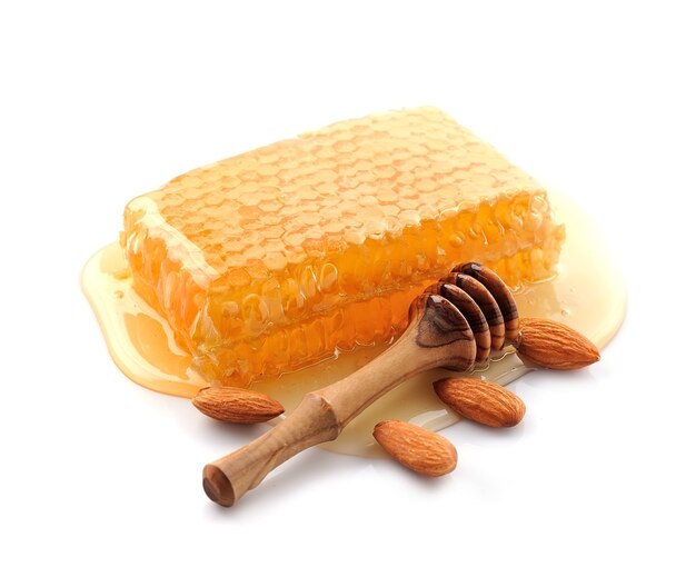 Honeycomb with almonds nuts closeup.