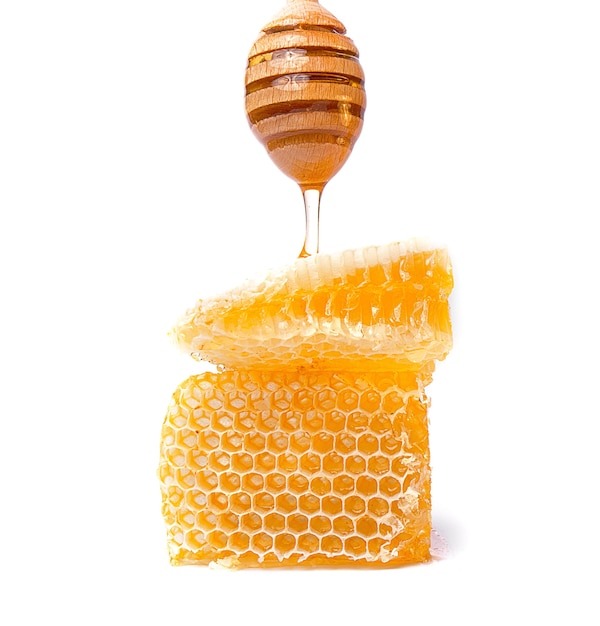 Honeycombs of bees filled with honey on a white