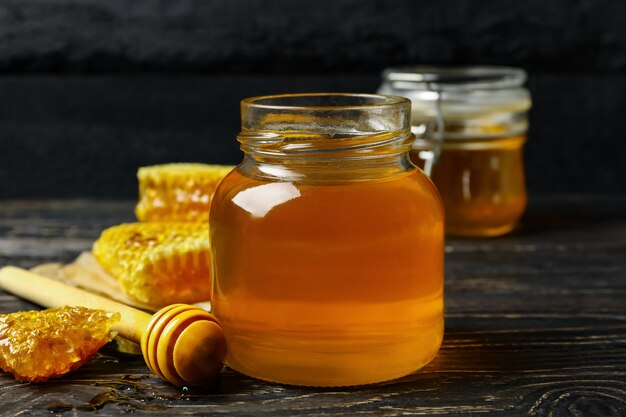 Honeycombs jar with honey and dipper