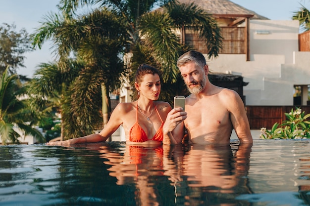 Honeymoon couple happy time in swimming pool