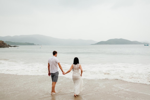 Honeymoon couple relax on beach Sea view and sandy beach in Asia Vietnam