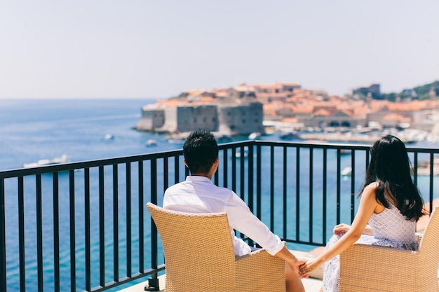 Honeymoon couple  on vacation in Europe with sea view Hands together back view Dubrovnik