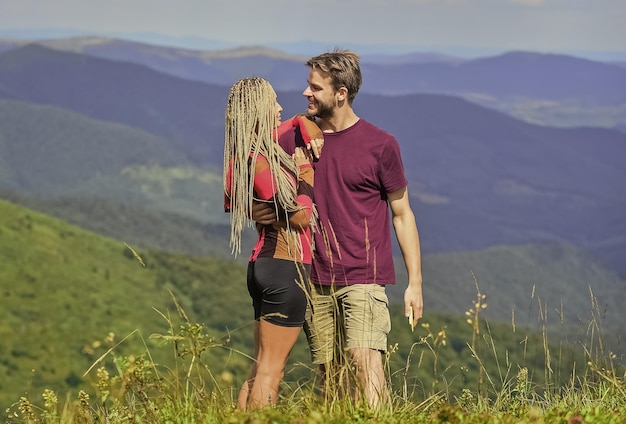 Honeymoon in highlands Two hearts full of love Beautiful couple embracing landscape background Couple in love summer vacation Love and trust Romantic relations Journey to mountains concept
