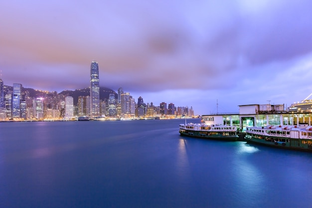 Hong Kong city skyline at sunset and twilight, panorama view Kowloon public pier