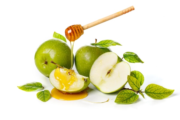 Honing druipend van houten stok op groene appels Witte achtergrond Rosj Hasjana Joods Nieuwjaar vakantieconcept