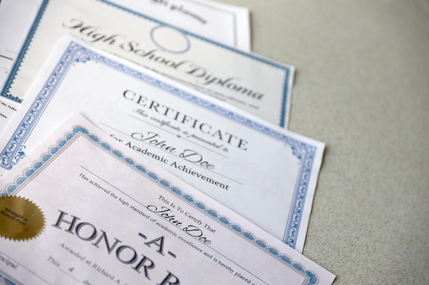 Photo a honor roll recognition certificate of achievement and high school diploma lies on table education documents