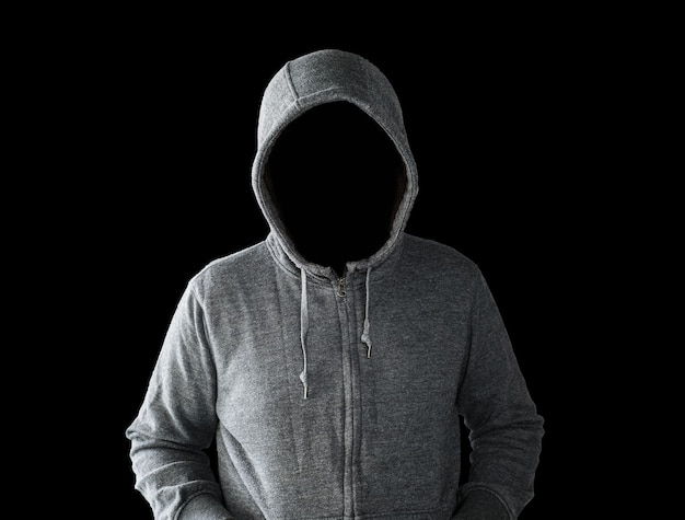 Hooded man with empty face isolated on black