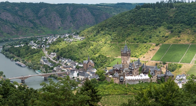 Hooghoekbeeld van de rivier door het kasteel tegen de bergen