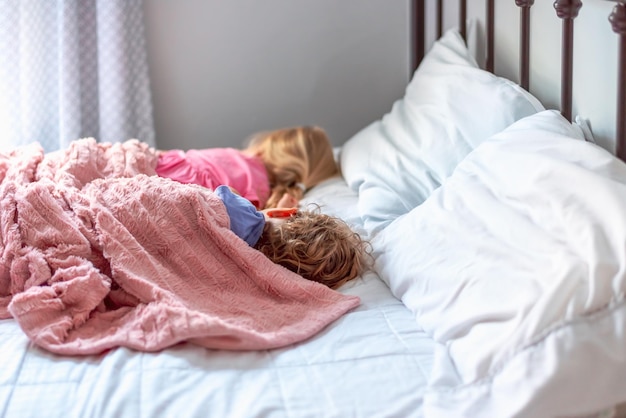 Hooghoekbeeld van schattige kinderen die op het bed slapen