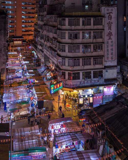 Foto hooghoekbeeld van verlichte straat te midden van gebouwen in de stad