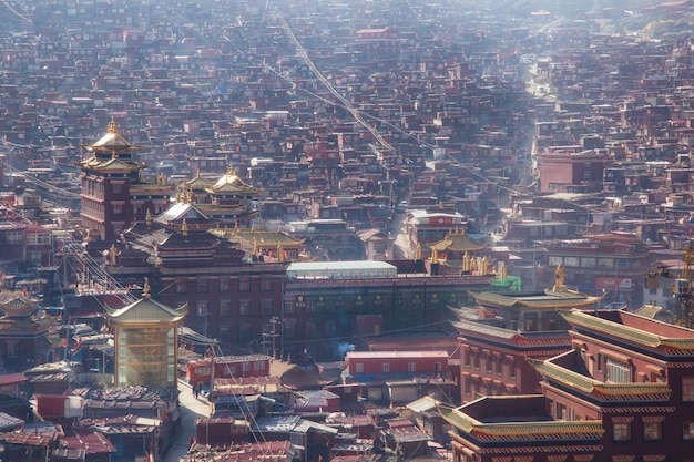 Hoogste meningsklooster in Larung-gar (Boeddhistische Academie) in een warme en mistige ochtendtijd