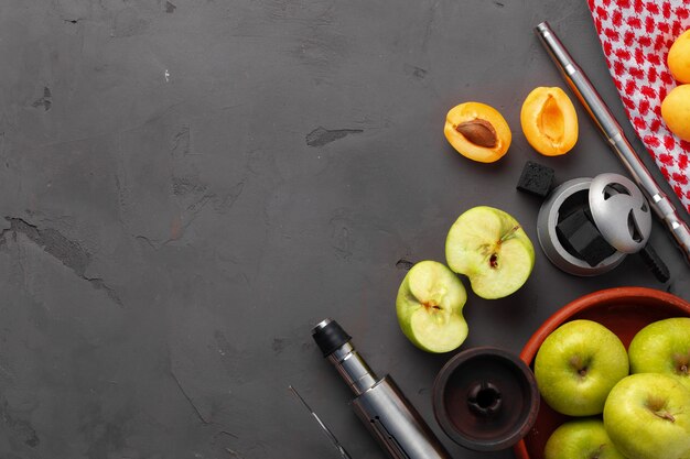 Hookah pipe and shaft with fruits on gray background, close up