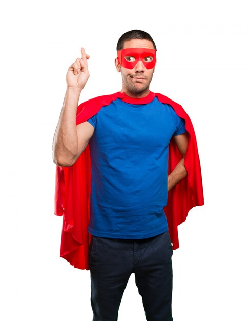 hopeful superhero finger cross gesture
